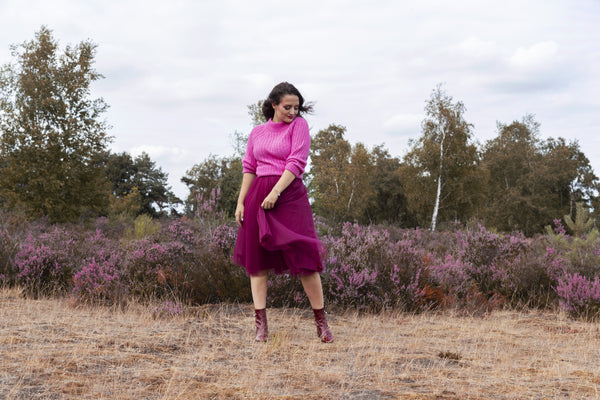 A woman wearing a Cherry Red Midi tulle skirt