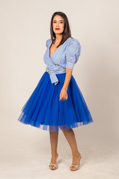 Young woman wearing an over the knee electric blue tulle skirt