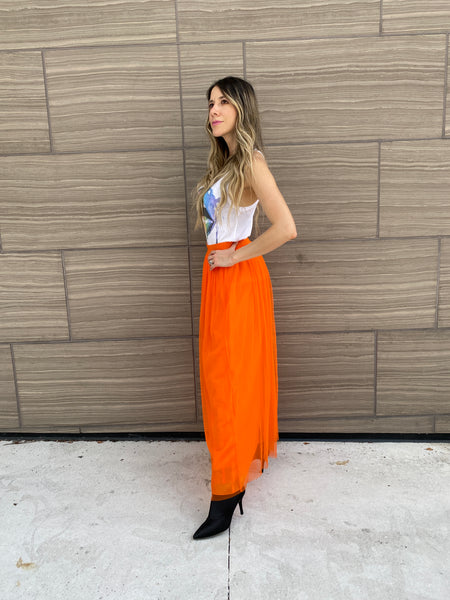 Pretty woman wearing an orange tulle skirt as a skirt and as a dress