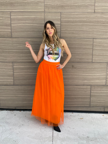 Pretty woman wearing an orange tulle skirt as a skirt and as a dress