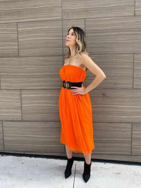 Pretty woman wearing an orange tulle skirt as a skirt and as a dress