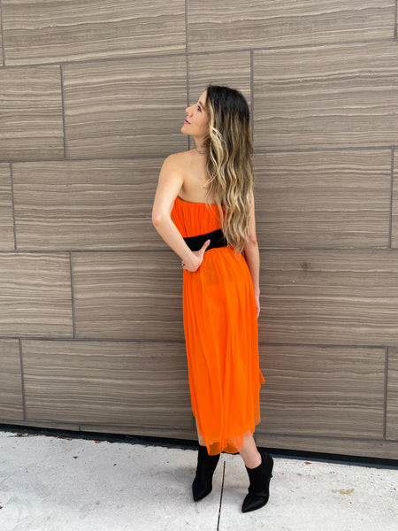 Pretty woman wearing an orange tulle skirt as a skirt and as a dress