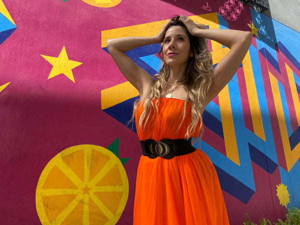 Pretty woman wearing an orange tulle skirt as a skirt and as a dress