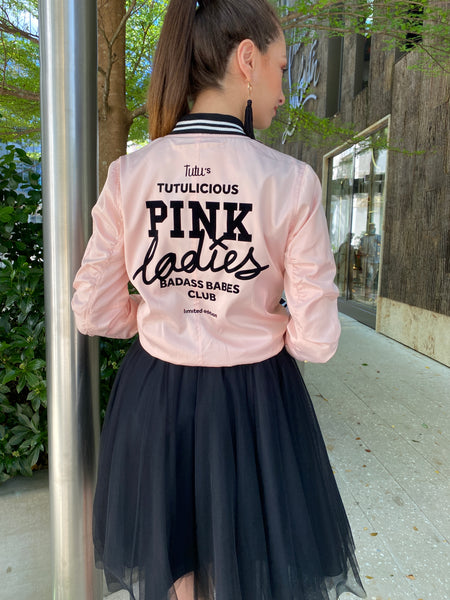 Fashion model wearing the Pink Ladies bomber jacket together with an over the knee Black tutu skirt