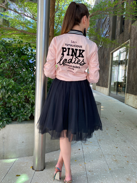 Fashion model wearing the Pink Ladies bomber jacket together with an over the knee Black tutu skirt