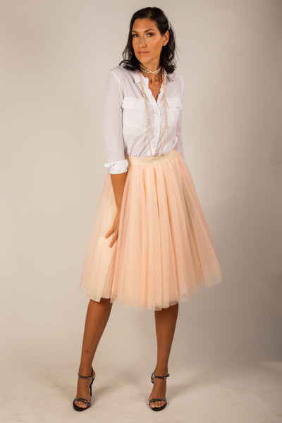 A tall model wearing the Midi Champagne tulle skirt