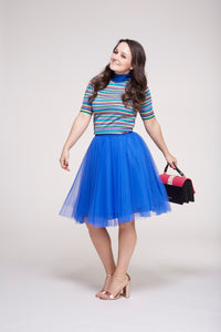 smiling model wearing a beautiful blue over the knee tutu tulle skirt by Sylvie Muller