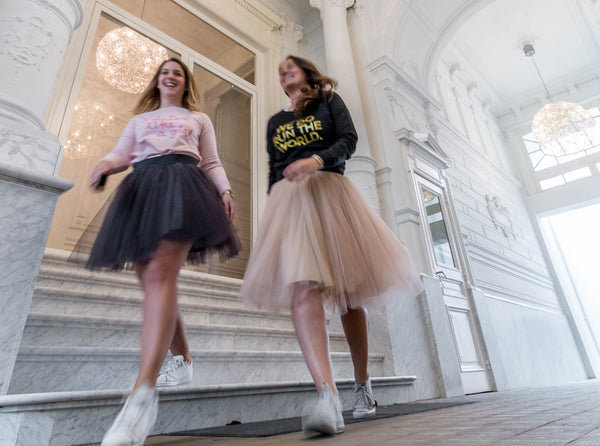 Two women wearing tutu skirts