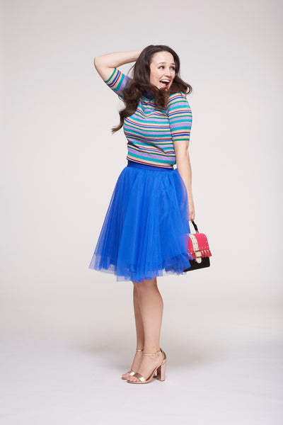 smiling model wearing a beautiful blue over the knee tutu tulle skirt by Sylvie Muller