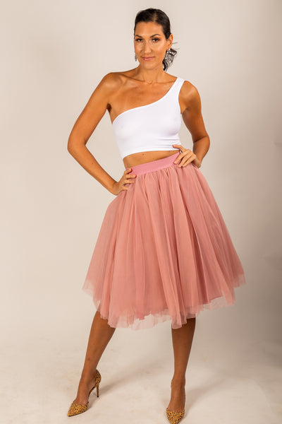 Pretty tall model wearing a light pink mid calf tulle skirt